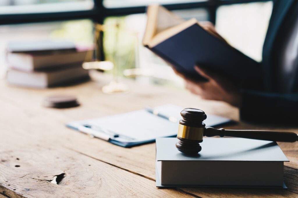 Businessman in suit or lawyer working on a documents. Legal law